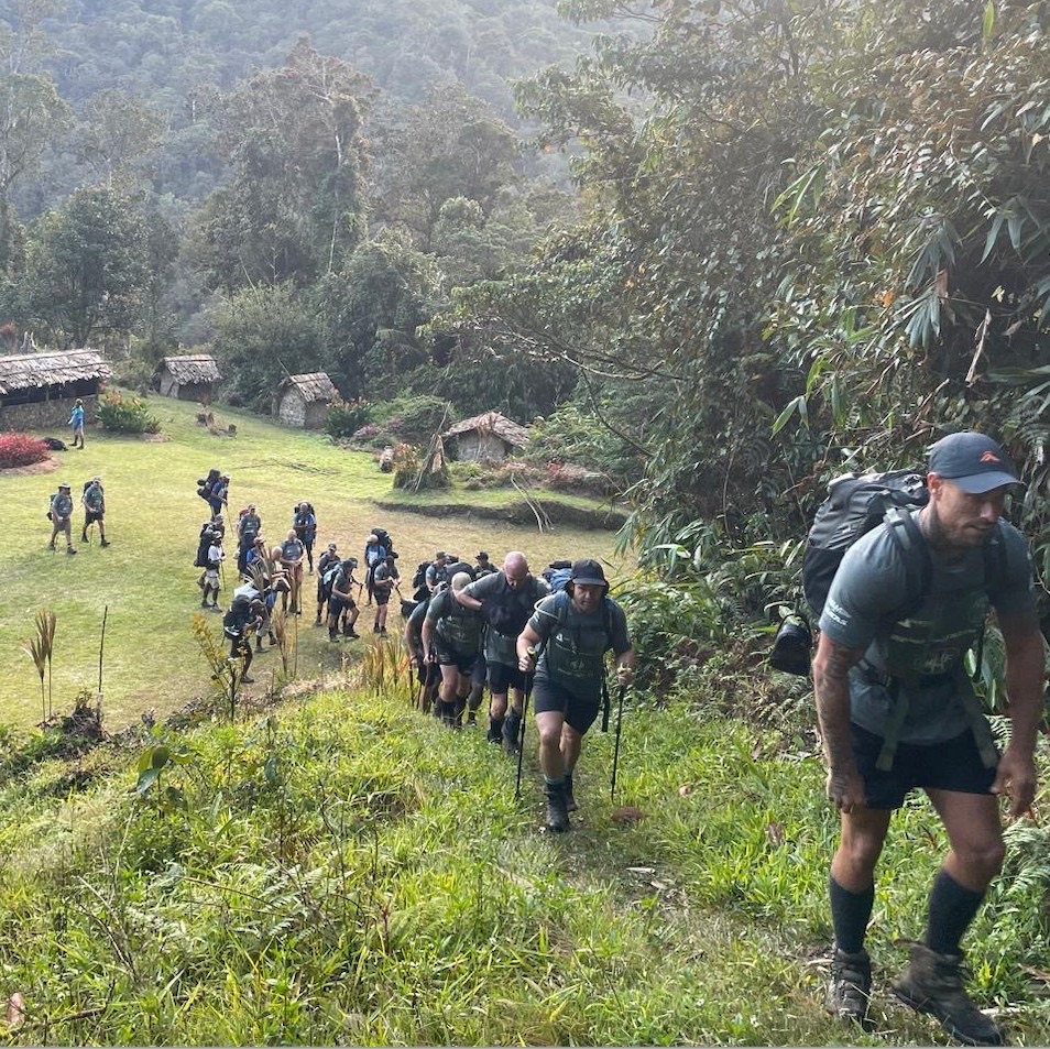 Team ascending a steep Kokoda ridge