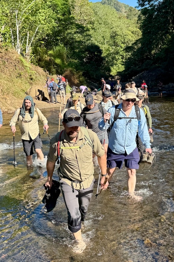 Leadership team river crossing on the Kokoda Track