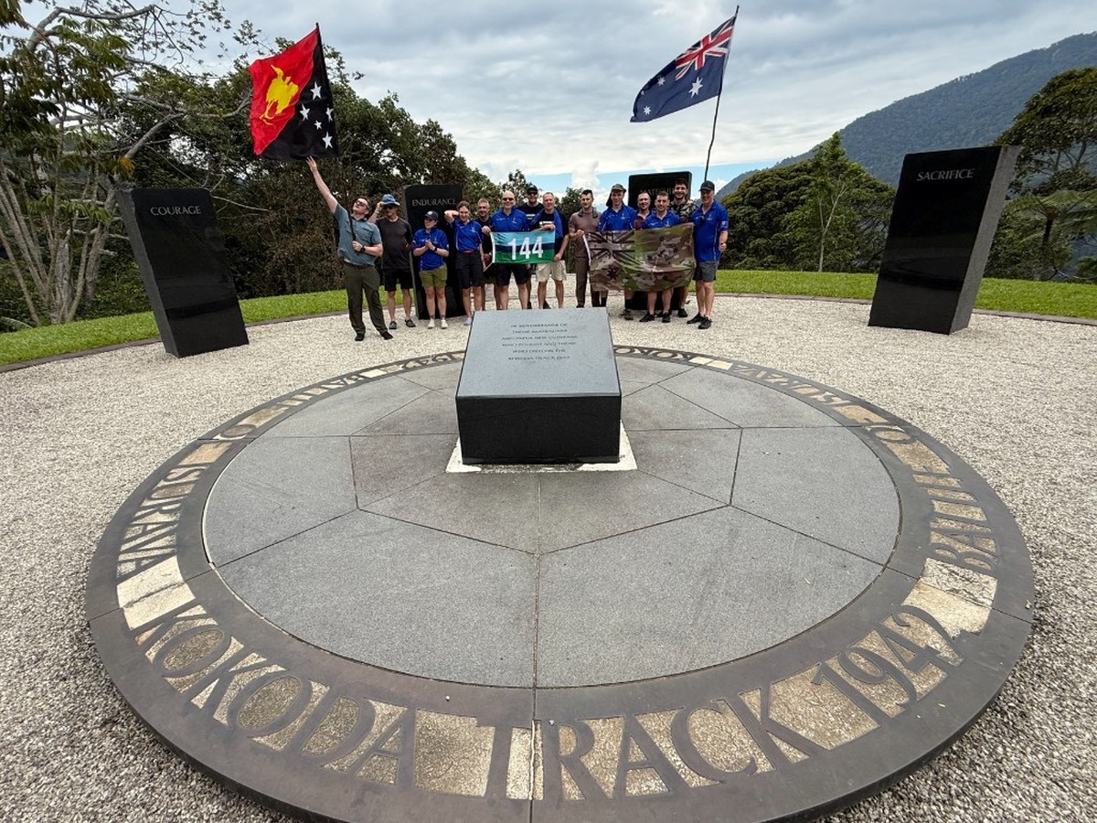 Isurava Memorial with 8 Sig members and flags