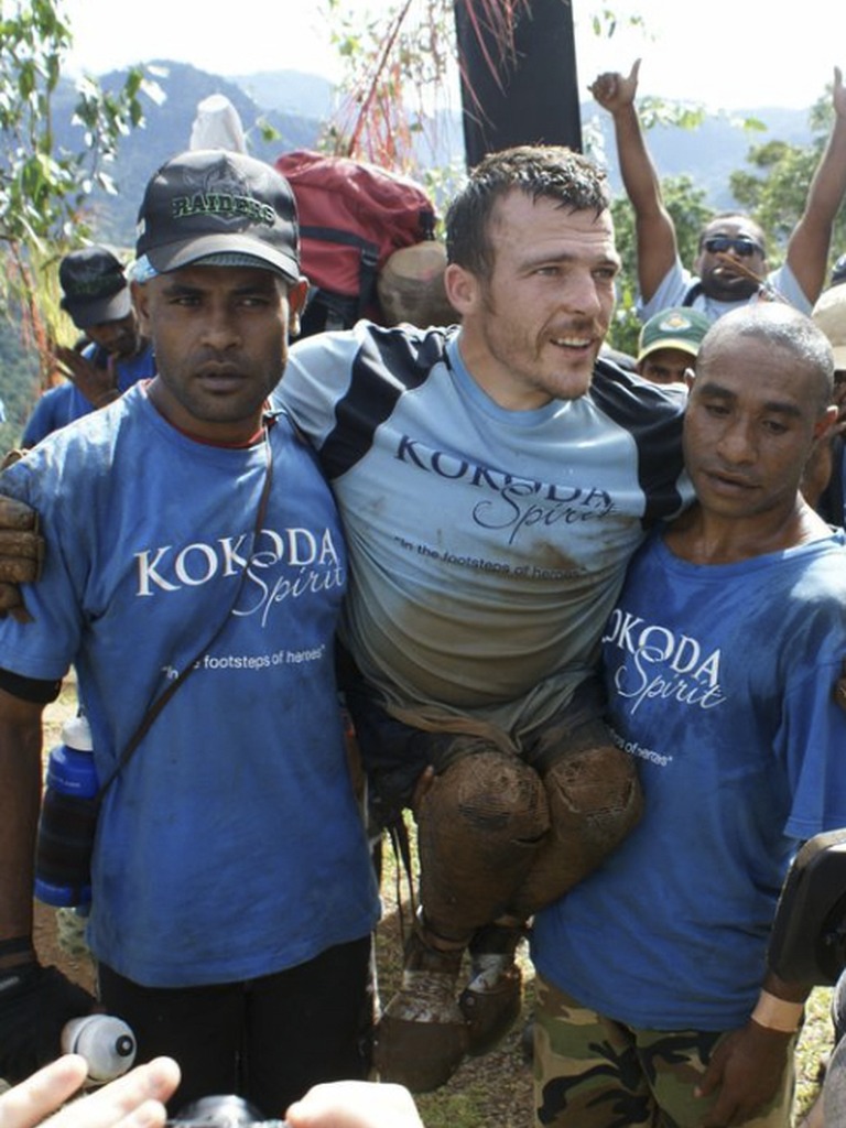 Supported trekker with local partners on the Kokoda Track